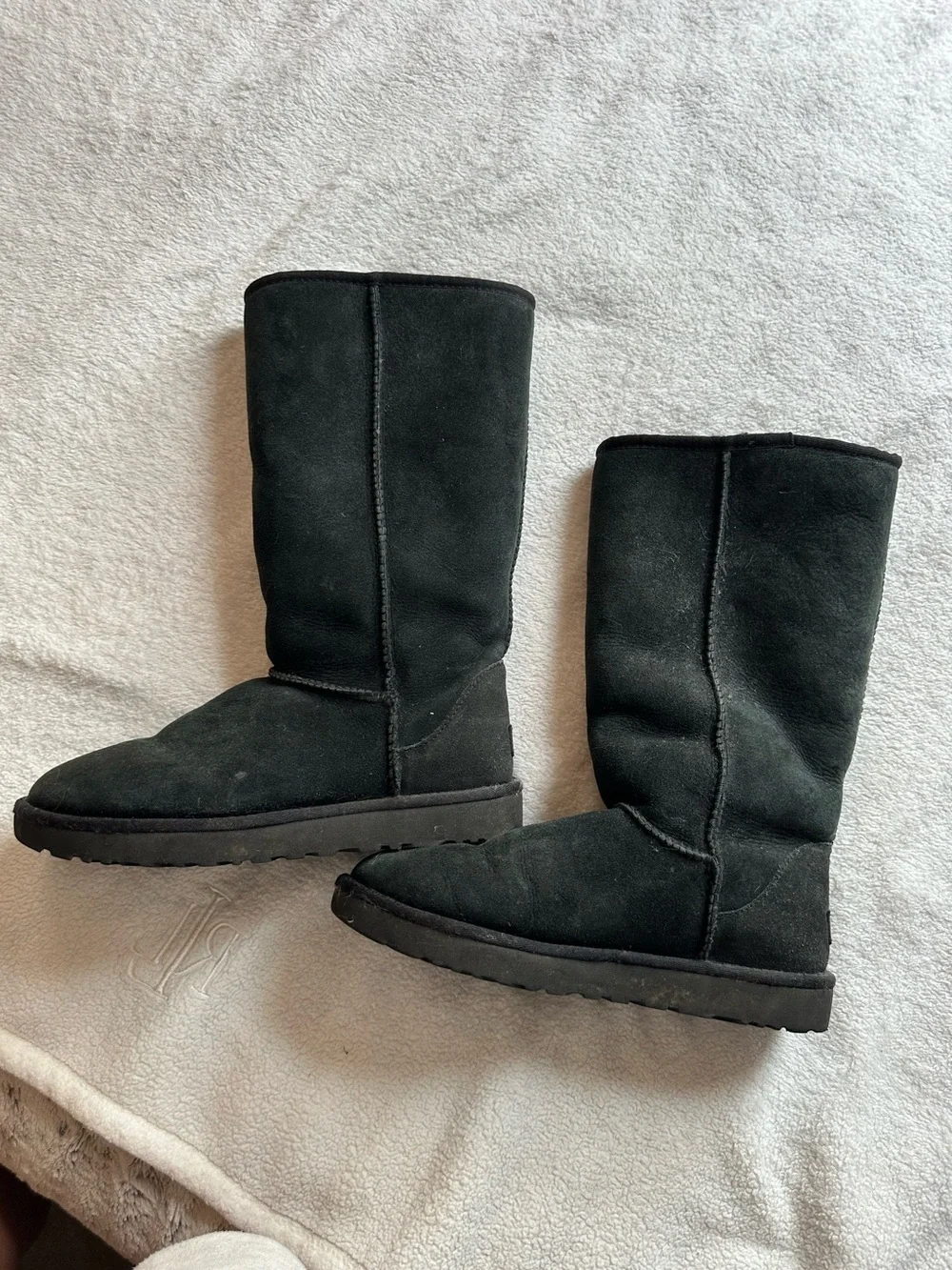 Tall black UGG boots